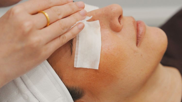 Skin being gently cleansed before assessment