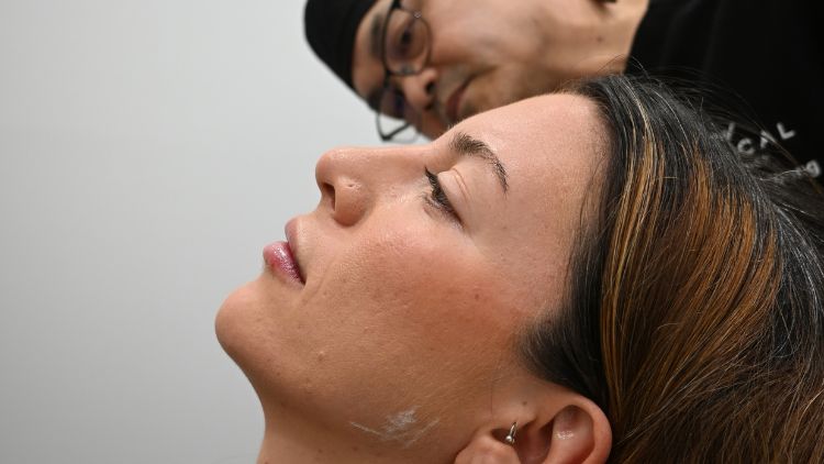 Dr Wong assessing facial anatomy before treatment