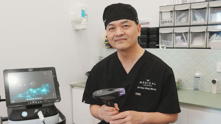 Dr Wong holding an RF microneedling handpiece