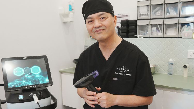 Dr Wong holding an RF microneedling handpiece