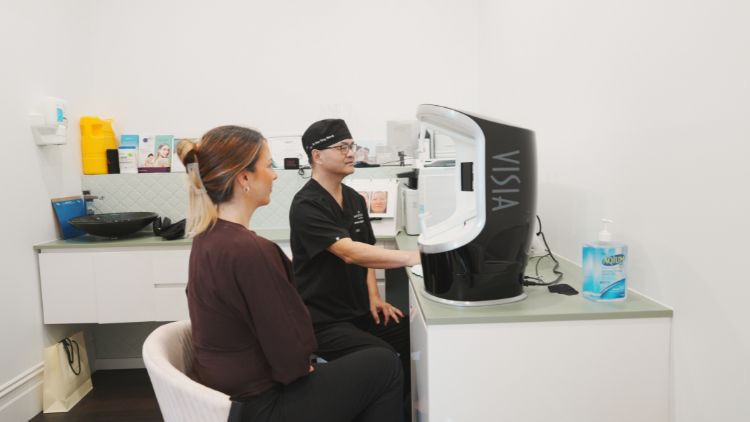 Dr Wong discussing skin assessment with VISIA imaging